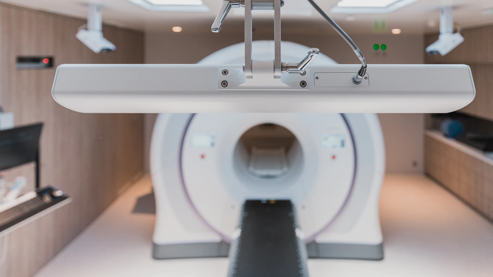 A radiology suite with a patient table and imaging gantry